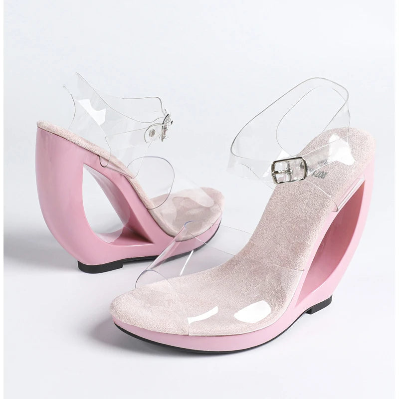 Pink wedge sandals with clear straps on a white background