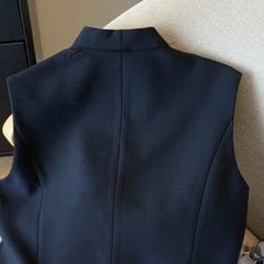 Navy blue vest on a beige surface