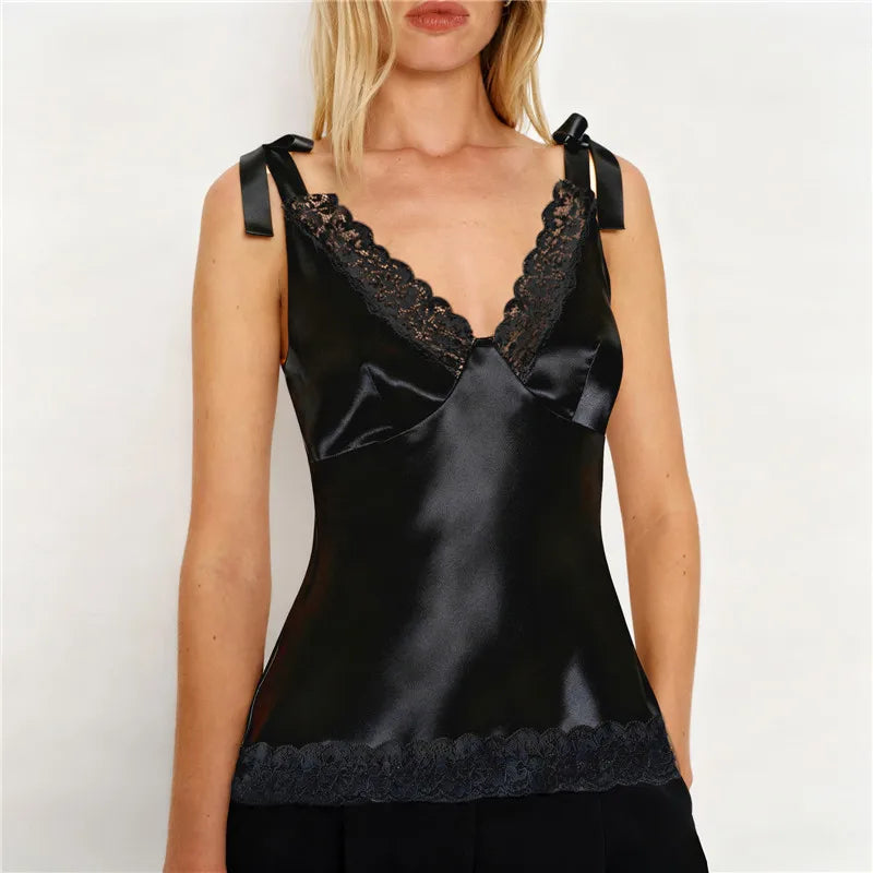 Black satin camisole with lace trim worn by a model on a white background