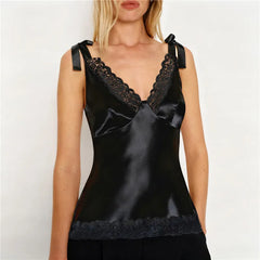 Black satin camisole with lace trim worn by a model on a white background