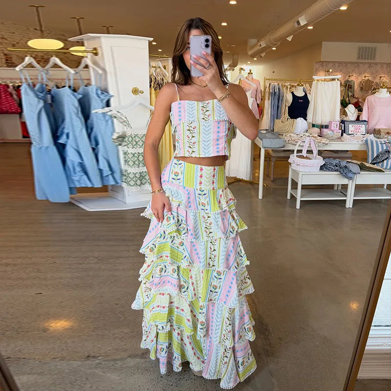 Printed ruffled crop top and cascading ruffle maxi skirt set displayed in store
