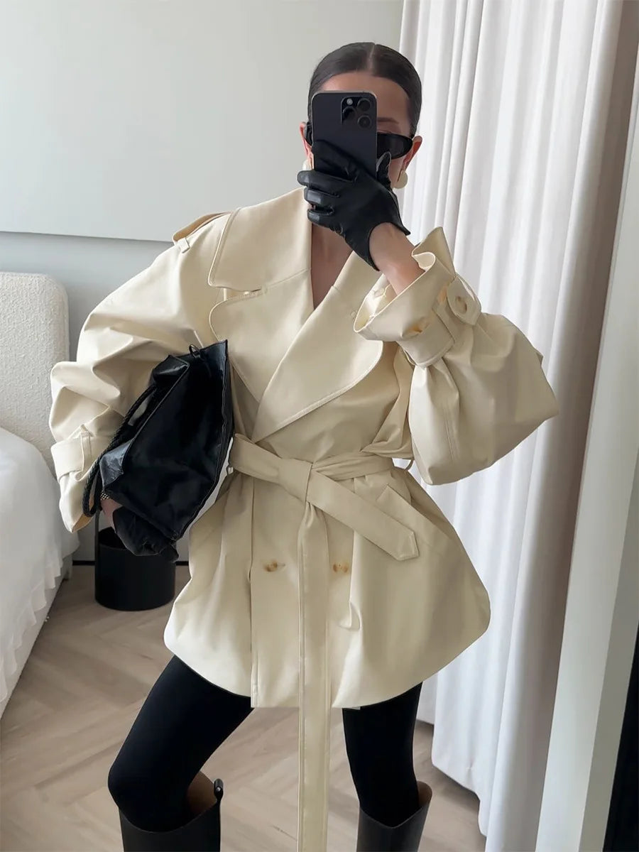 Model wearing a cream lapel double-breasted belted jacket