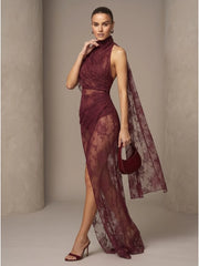 Side profile of model wearing high neck draped lace maxi dress