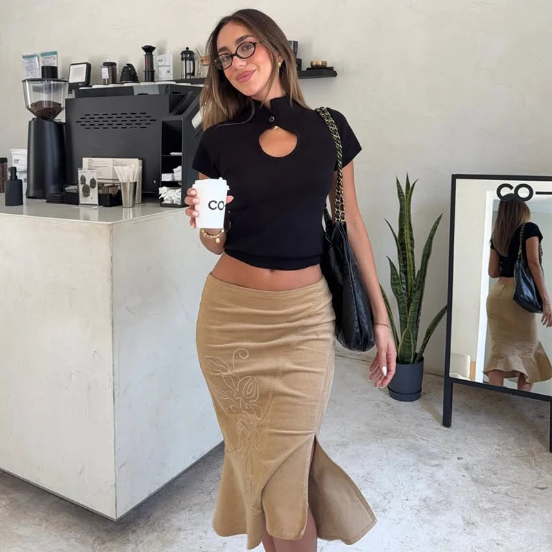 Woman holding a coffee cup in a cafe setting
