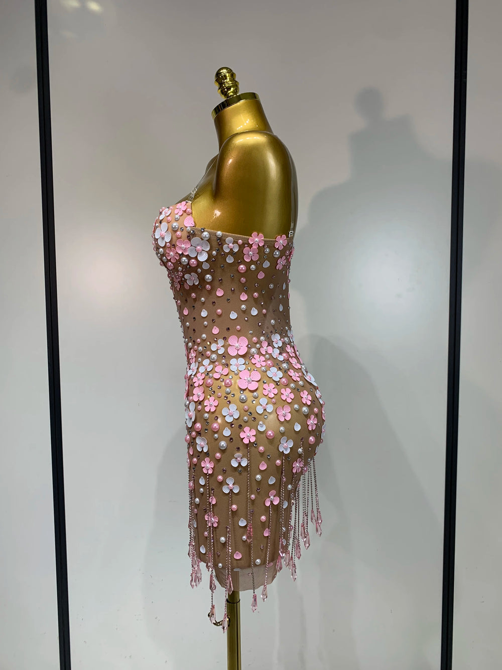 Appliqued flower mini dress, three-quarter side view.