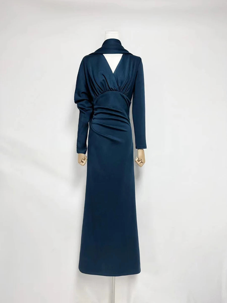 Navy blue dress on a mannequin against a white background