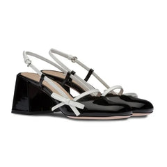 Close-up of black patent slingback bow block heels