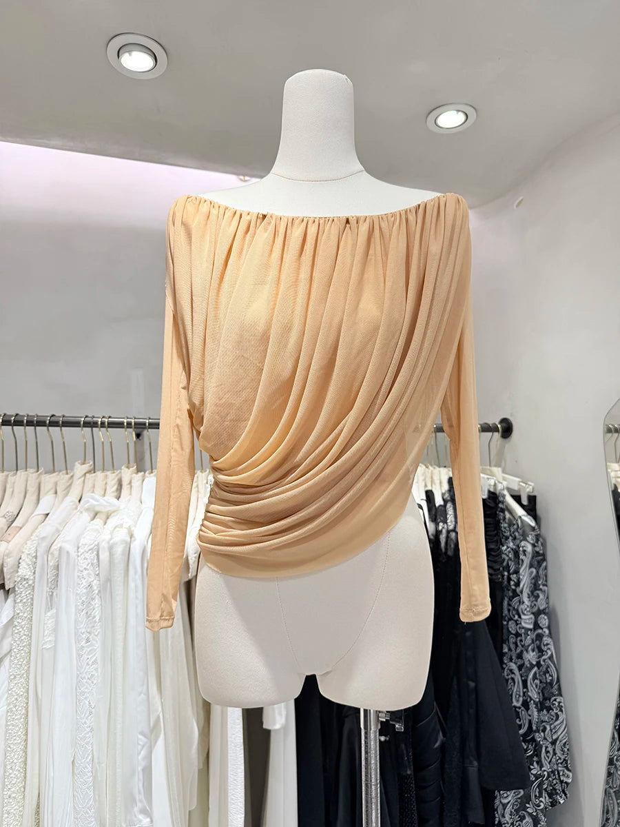 Beige off-shoulder top on a mannequin in a clothing store setting.