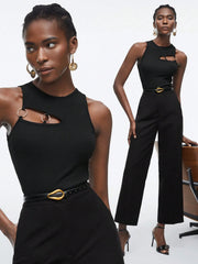 Woman wearing a black outfit with gold accents on a white background