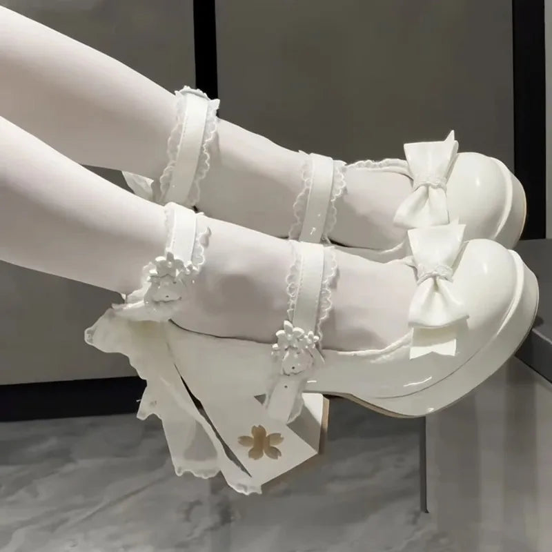 White high-heeled shoes with decorative bows and ruffles on a neutral background