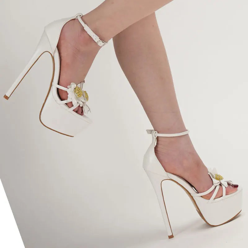 White high-heeled shoes with floral details
