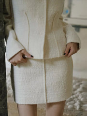 Close-up of a person wearing a textured white coat with a blurred background