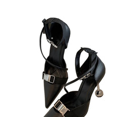  Pair of black stiletto pumps with a metal buckle detail, showcasing their elegant design.. Golden Atelier 2