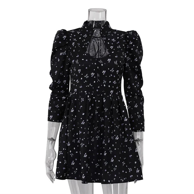 Black floral dress on a mannequin against a white background