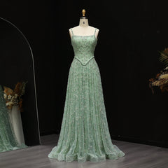 Green evening gown on a mannequin against a dark background