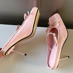 Close-up of the delicate butterfly-knot accent on the toe of the shoe. Pink