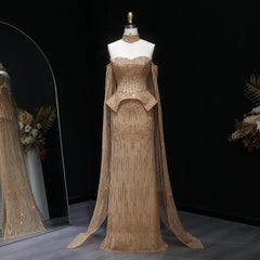 Beige evening gown with cape on a mannequin against a dark background