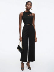 Woman wearing a black jumpsuit with cut-out design on a white background