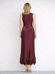 Back view of a burgundy sleeveless O-neck maxi dress with fringe trim.