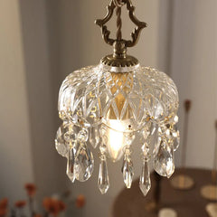 A modern crystal pendant light with LED bulbs, casting a warm glow in a stylish living room.  Golden Atelier 2