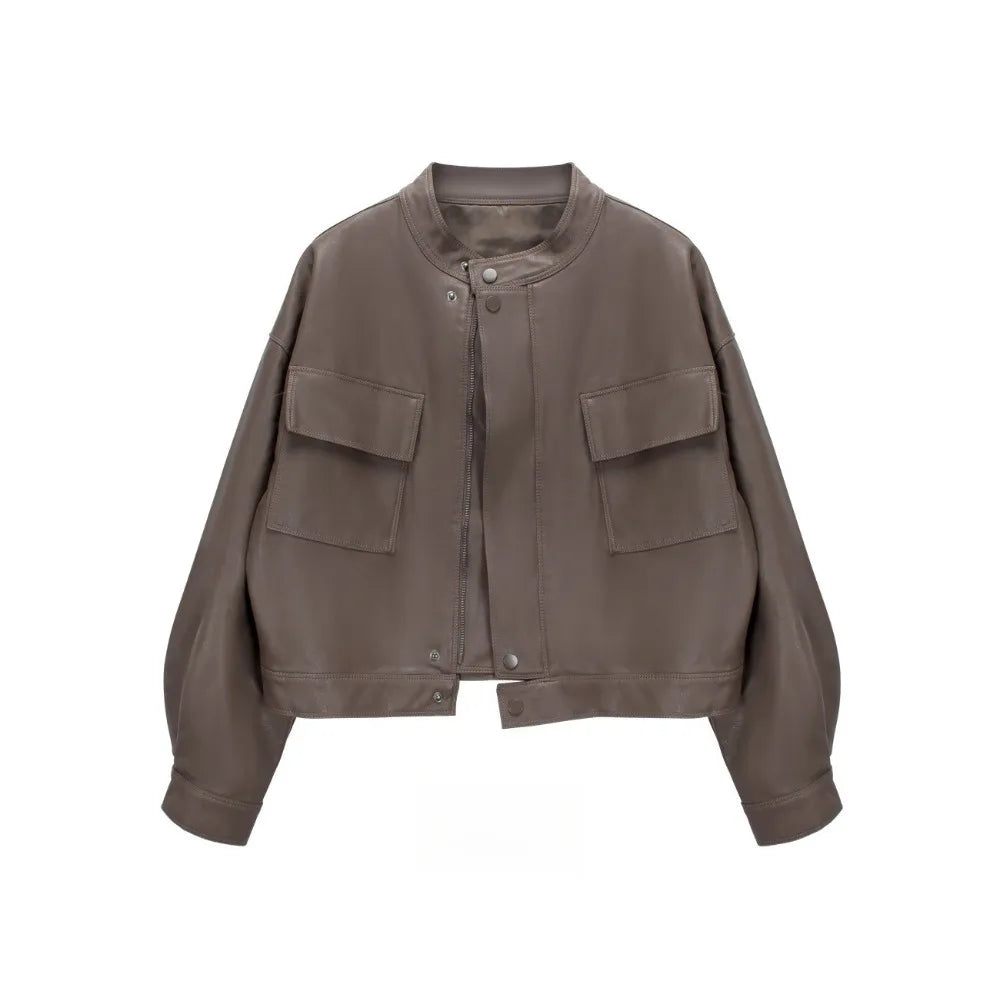 Brown cropped faux leather jacket with round neck and dual front pockets.