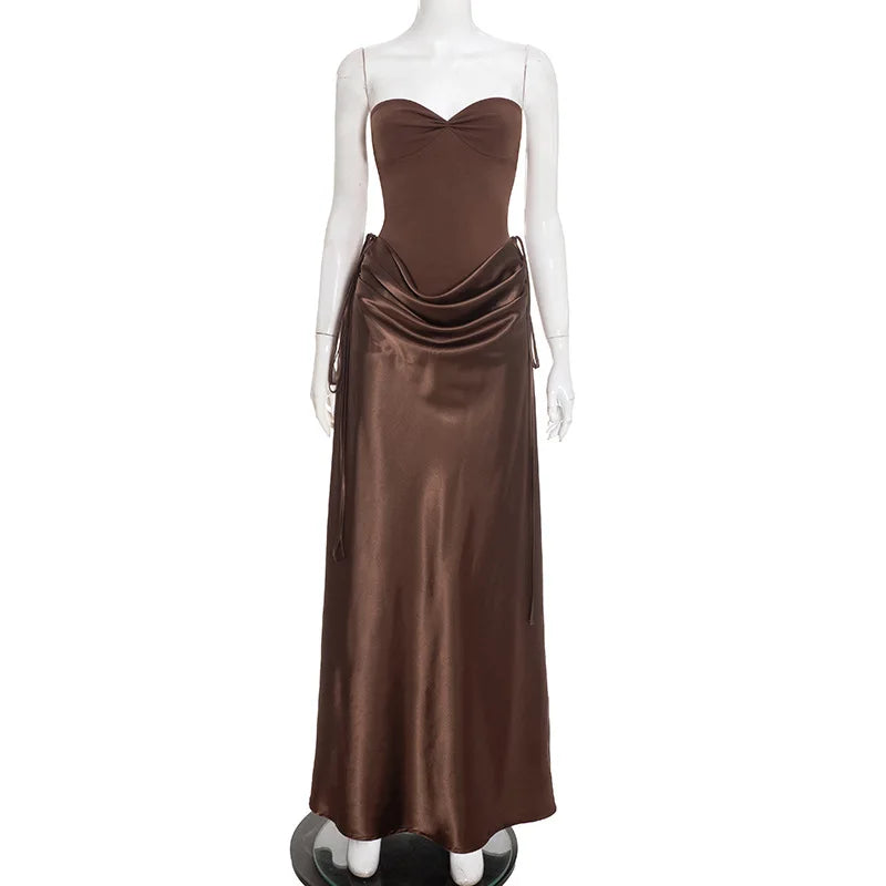 Brown evening gown on a mannequin against a white background