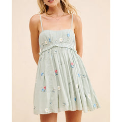 Light green dress with floral embroidery on a beige background
