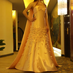  A model wearing the lilac 3D floral gown, showcasing its elegant silhouette and the daring high slit. Golden Atelier 10