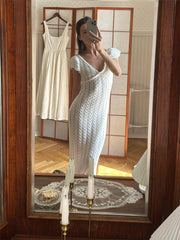 White ruffled knit maxi dress with a V-neck.
