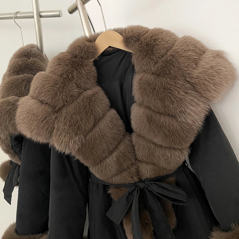 Black coat with brown fur collar on a hanger
