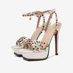 Pair of white satin platform crystal embellished stiletto heels with red and green crystals