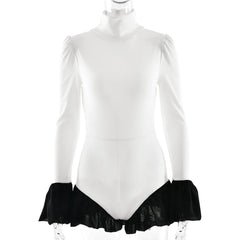 White long-sleeve leotard with black ruffled bottom on a mannequin against a white background