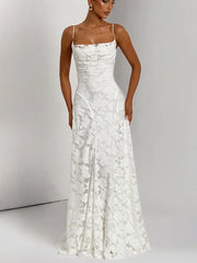 Woman wearing a white lace dress against a gray background