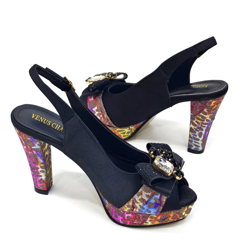 Black high-heeled shoes with colorful platforms and decorative buckles on a white background