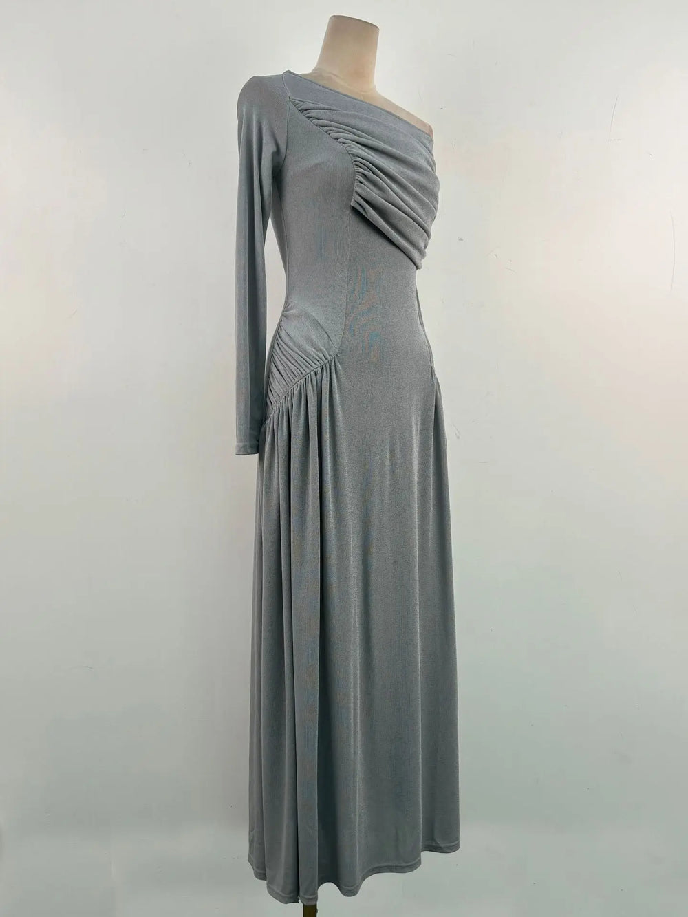 Gray one-shoulder dress on a mannequin against a plain background