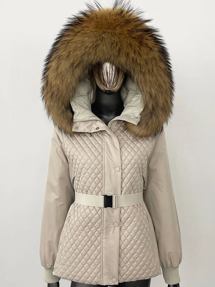 Beige quilted jacket with a large fur hood on a mannequin against a white background