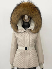 Beige quilted jacket with a large fur hood on a mannequin against a white background