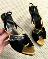 Black and gold stiletto heeled sandals with crisscross straps