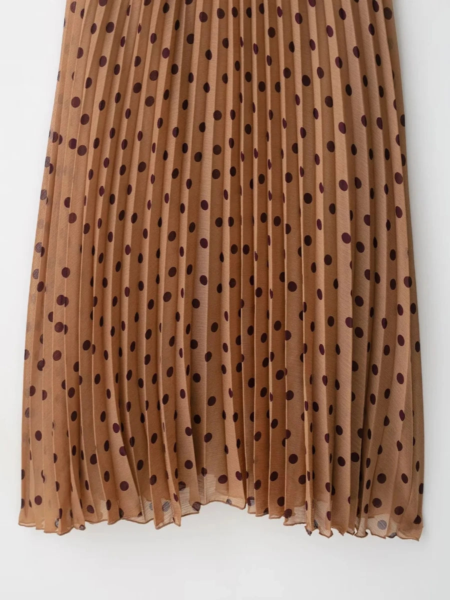 Brown pleated skirt with black polka dots on a white background