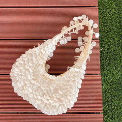 White bib with floral details on a wooden surface