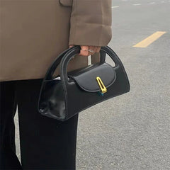 A woman carrying the crossbody bag, highlighting its versatility and edgy style. Golden Atelier 4