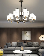 Modern LED chandelier with glass pendants, casting a warm glow in a stylish living room. Golden Atelier 2