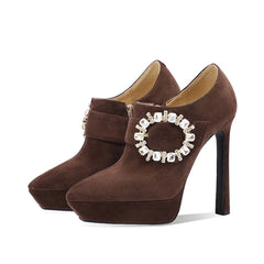 Pair of brown stiletto heel booties with rhinestone buckle