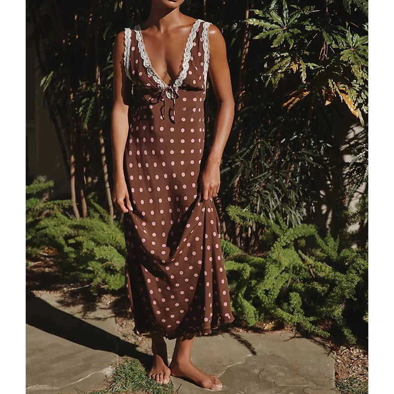 Polka dot maxi dress with lace trim and tie-back detail.