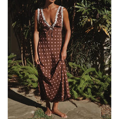 Polka dot maxi dress with lace trim and tie-back detail.
