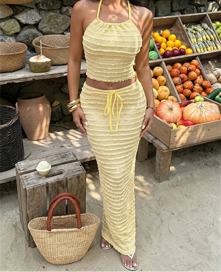 Textured knit halter crop top and column skirt set in yellow.