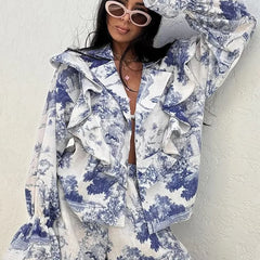 Person wearing a blue and white floral outfit with a textured background