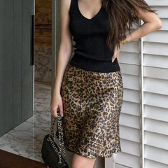 Model wearing leopard print A-line skirt with black tank