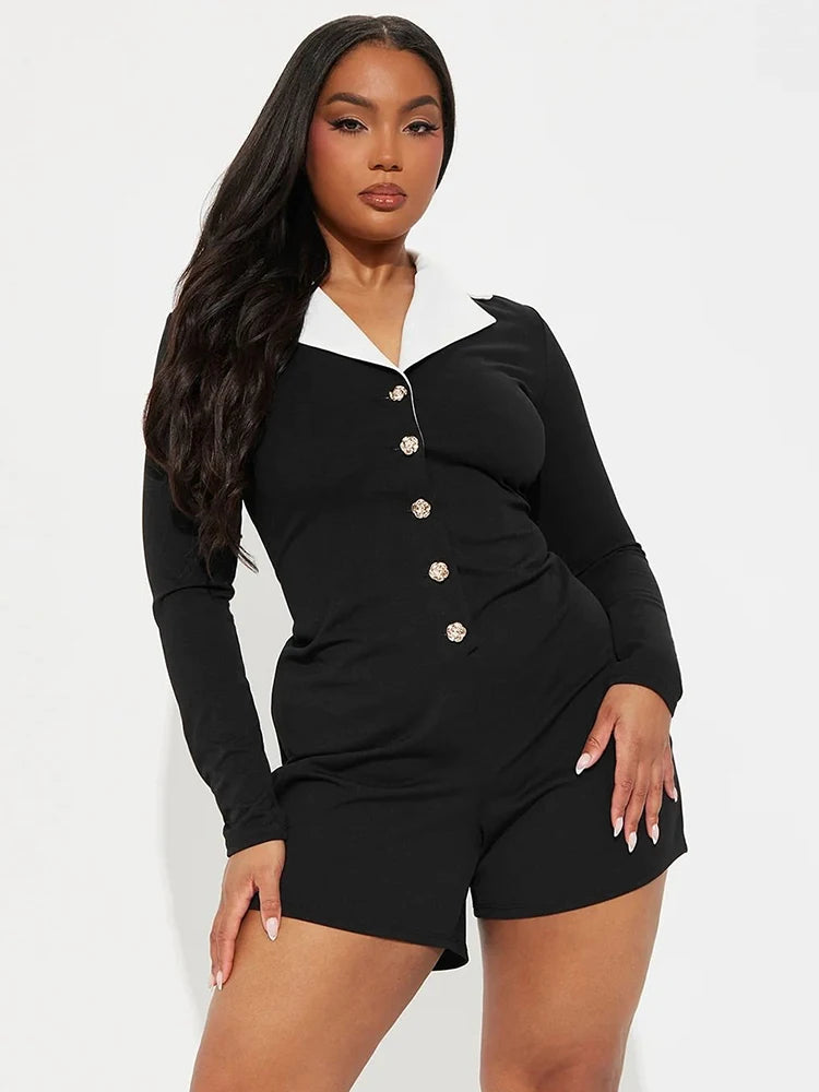 Woman wearing a black outfit with white collar and buttons 