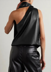 Person wearing a black sleeveless top and pants against a plain background